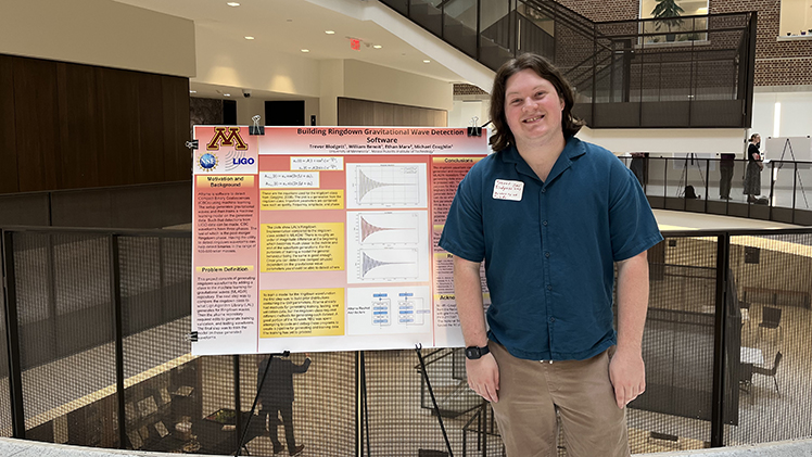 Trevor Blodgett, a dual major in astrophysics and applied mathematics, stands next to his research poster.