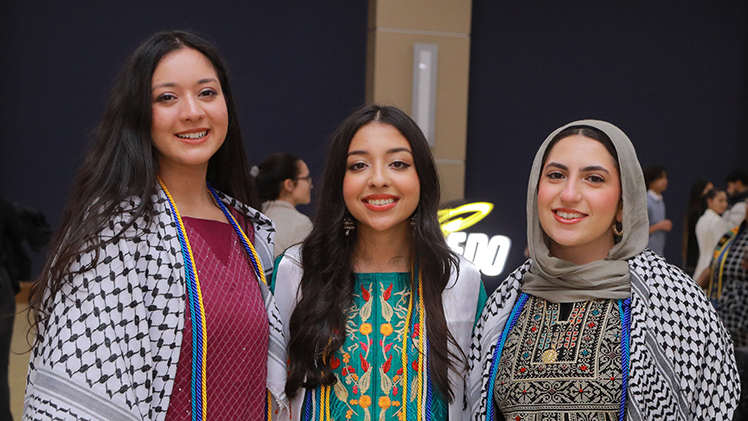 Photo of three female UToledo students posing for the camera at the 2023 Multicultural Graduation Ceremony.