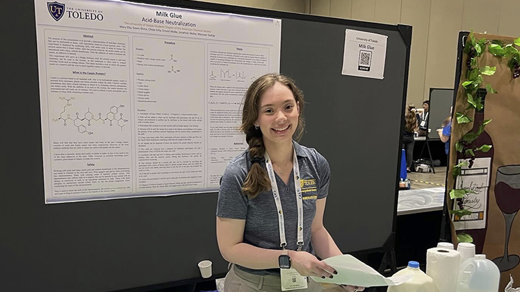 Photo of UToledo senior chemistry student Mary Eby making a research presentation.