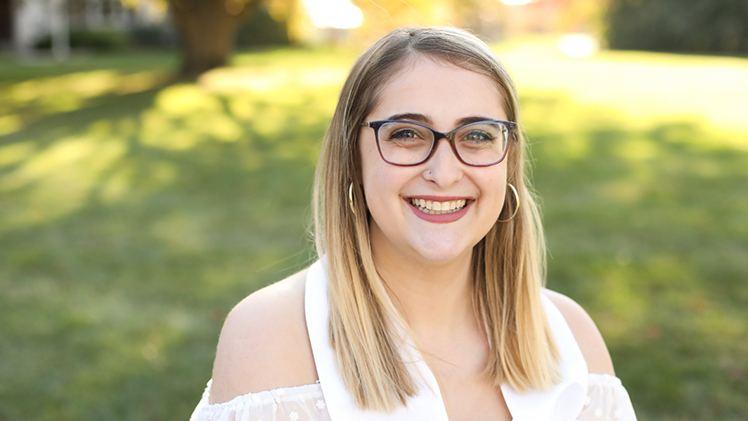 Outside portrait of UToledo senior Jordan Slutsky, who graduates Dec. 14 with dual degrees in disability studies and political science.