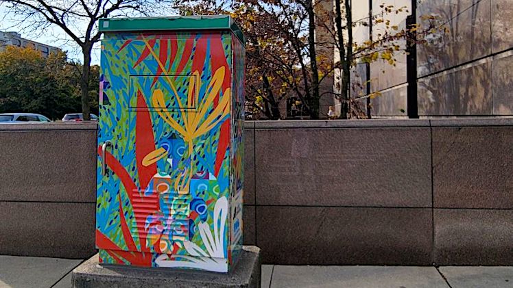 An abstract design by Barbara Miner, professor and chair of the Department of Art, was recently selected by the Arts Commission as a colorful new signal box wrap located at the corner of Jackson Boulevard and Michigan Avenue, outside of the Domestic Relations Court in downtown Toledo.   