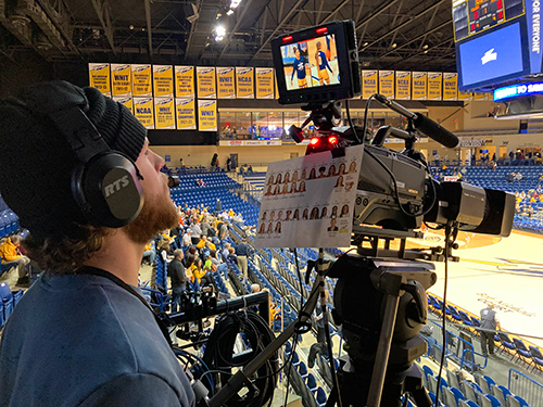 Student Nick Schroeder operates the slash camera for a women’s basketball game during the 2022-23 season.