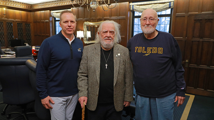 From left, Interim President Matt Schroeder; Dr. Seamus Metress, professor emeritus in the Department of Anthropology in the College of Arts and Letters; and Dr. Don Wedding, an associate professor in the Department of Management in the John B. and Lillian E. Neff College of Business and Innovation, pose for a photo in the president's office before a special lunch to recognize Metress and Wedding's decades of deep commitment and dedicated service to the University.