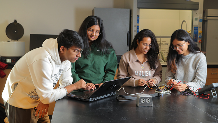 : Bioengineering seniors, from left, Rutvij Chaudhary, Anushka Mishra, Alisha Onkar and Laya Kalita test the medical technology device they plan to present at the College of Engineering’s Senior Design Expo on Friday, Dec. 6. Breath Buddy is a wearable device designed to identify asthmatic breathing patterns in children.