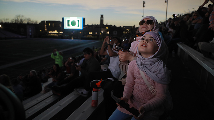 Fatemeh Asnaashary and daughter, Zahra, from Dearborn, Michigan, were among the hundreds of eclipse watchers in Glass Bowl Stadium in April.