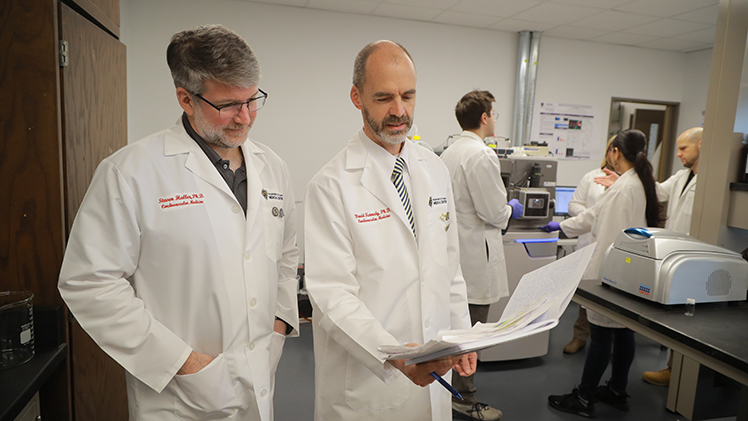 Dr. David Kennedy, left, serves as co-director of the Great Lakes Center for Fresh Waters and Human Health, which UToledo was chosen to lead in June. Dr. Steven Haller, right, will be conducting critical research into the full health effect of exposure to aerosolized toxins from the Lake Erie algal bloom as part of the project. Both are associate professors of medicine.