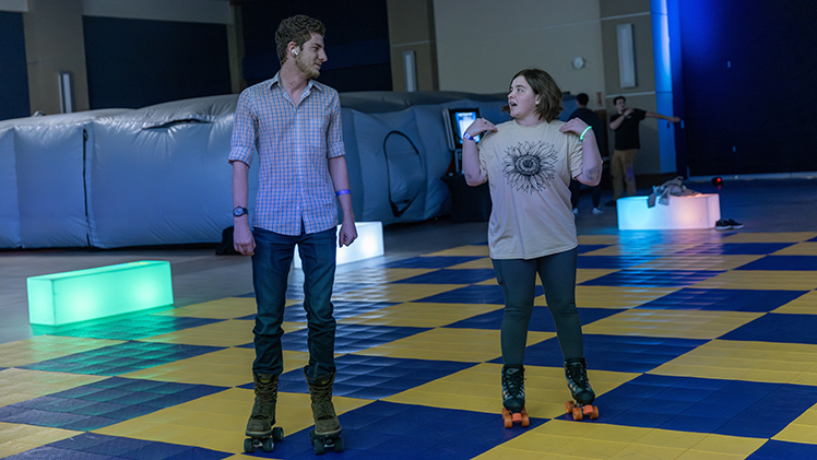 Eric Burdue, left, a senior mechanical engineering technology student and Grayc Hagerman, a freshman nursing student, roller skate in Thompson Student Union Auditorium.