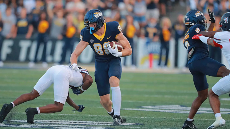 Rockets tight end Anthony Torres avoids a tackle after catching the ball during a game.