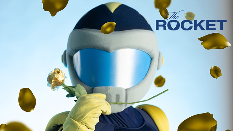 Promotional image of Rocky holding a golden rose for this season of The Rocket, watch as UToledo students fight for the golden rose of school spirit.