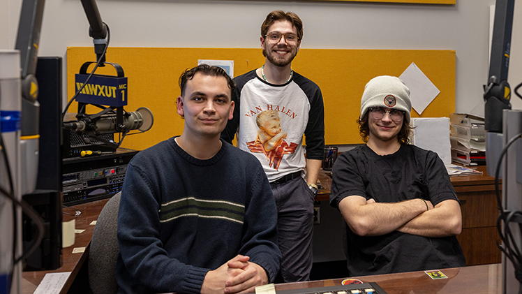 A trio of WXUT 88.3 FM student staff members — from left, Trip Floyd, Asa Kridelbaugh and Tanner Schultz — pose for a photo at the UToledo student-run station.