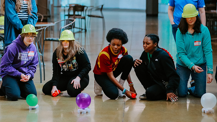 Photo of a group of girls participating in an Introduce a Girl to Engineering program series activity.