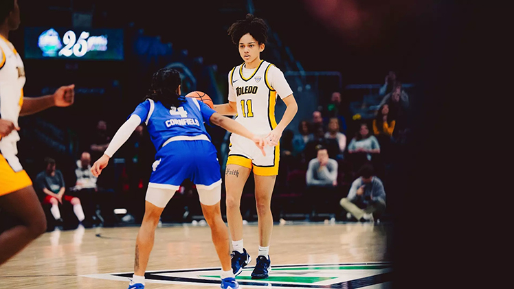 Toledo women’s basketball player Destiny Robinson dribbles the ball as an opponent positions herself to guard Robinson during a game.