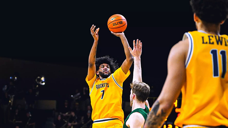 Photo of men's basketball player Isaiah Adams about to shoot over an opposing player during Toledo's 90-85 overtime win over Ohio on Thursday.