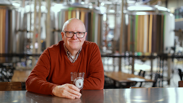 Dr. Neil Reid enjoys a pint at the Fieldhouse at Inside the Five, a craft brewery taproom just off Main Campus. Reid, a professor in the Department of Geography and Planning, is an expert in the craft brewing industry.