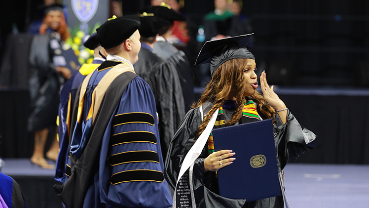 Rashara Derden blows a kiss after graduating with a master of business administration degree and a doctor of pharmacy degree.
