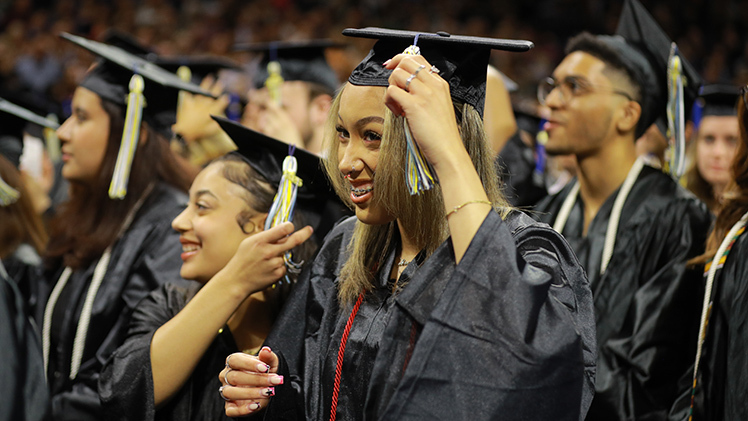 Kayliana Ortiz moves her tassel after the conferring of degrees by Interim President Matt Schroeder during The University of Toledo’s Saturday afternoon commencement ceremony. A senior at Toledo Early College, Ortiz graduated with an associate of arts degree in general studies.