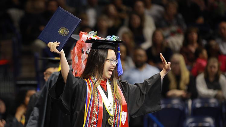 Mai Vien Hoang Mang celebrates after graduating with a bachelor of business administration degree in operations and supply chain management.