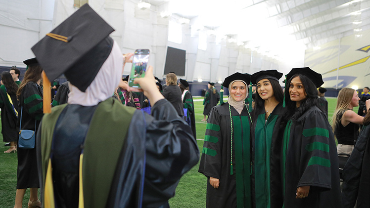 Before the commencement ceremony, Noor Hassan took a photo of, from left, Marwa Hassan, Meghana Ranabothu and Shangari Varatharajan. All four students received medical degrees at the ceremony.