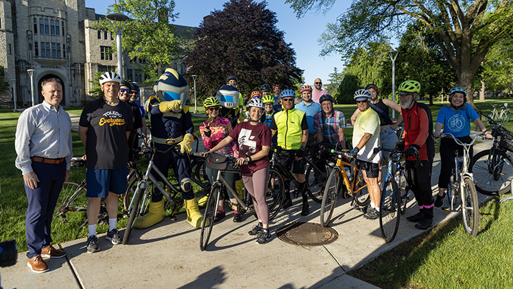 From left, University of Toledo Interim President Matt Schroeder and mascots Rocky and Rocksy greeted Toledo Mayor Wade Kapszukiewicz and fellow cyclists to campus Friday morning during national Bike to Work Day.