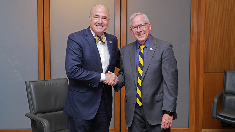 Dr. James Holloway shakes hands with Patrick Kenney, chair of the UToledo Board of Trustees, following Thursday morning’s announcement during a special board meeting that Holloway will assume the role of the University’s 19th president on July 15, succeeding Interim President Matt Schroeder. 
