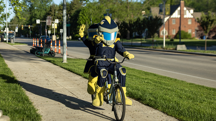 Rocky and Rocksy saddled up to join cyclists Friday at an event aimed at encouraging Toledoans to consider bicycling or using pubic transportation for their daily commute.