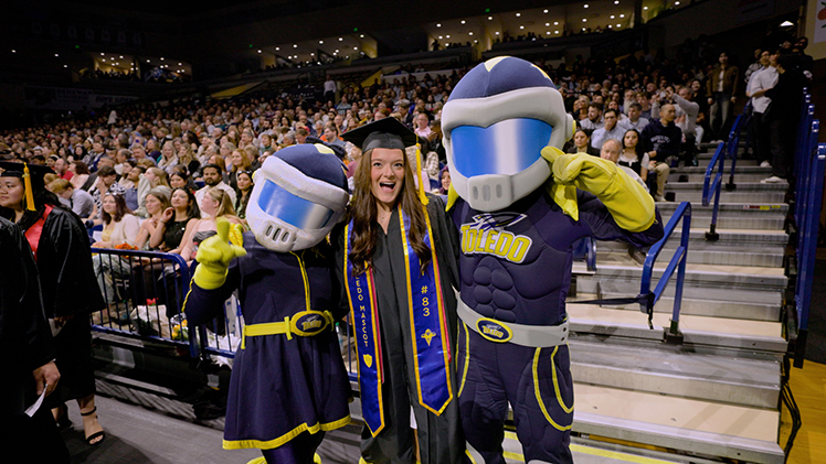 Jenna Muetze poses with Rocky and Rocksy during the 2025 spring commencement ceremony. Jenna was Rocky No. 83.