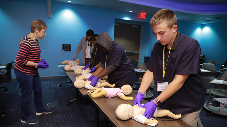 Cuper Kania, who will be a freshman at Perkins High School near Sandusky this fall, practices infant CPR during last week’s CampMed program on Health Science Campus.