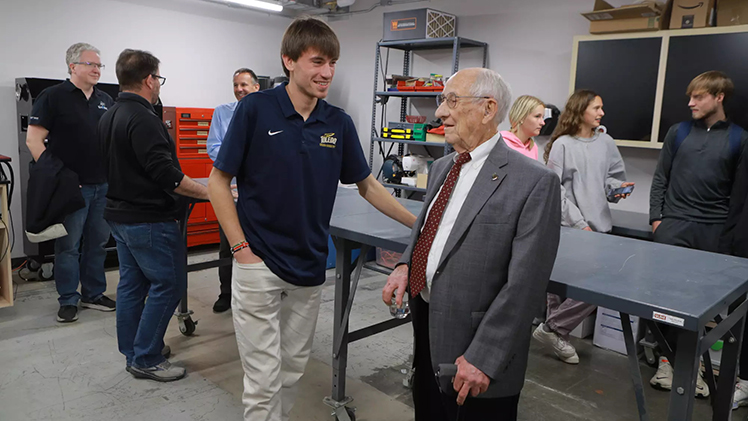 Joshuah Taylor talks with Paul Hotmer, the namesake of the makerspace in the North Engineering building on Main Campus.