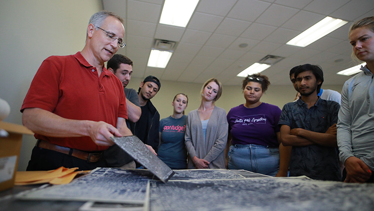 Dr. Kevin Czajkowski, a Distinguished University Professor in the Department of Geography and Planning, works on a project with UToledo students.