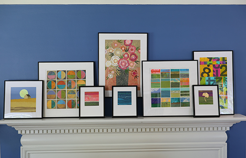 A collection of framed paper collage artworks by local artist Steven Wipfli arranged on his fireplace mantel. 