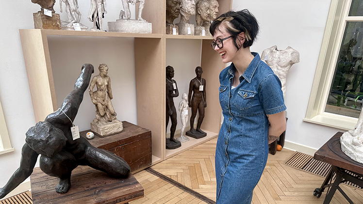 Tatum Hartford, an art history senior, poses next to a little-known sculpture she researched that is in the collection of the Toledo Museum of Art at the Georg Kolbe Museum in Berlin.