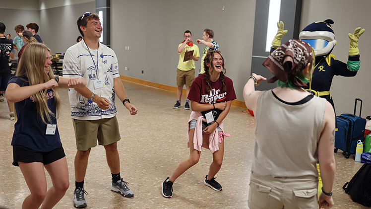 Incoming freshman Rosemary Crook, from left to right, Rocky River, Ohio, and Hale Hensley from Lima, both pre-nursing students, laugh as Claire Bishop, an early childhood education student, reacts to being correctly guessed during an ice-breaking game at UToledo’s Summer Freshman Camp on Friday afternoon.