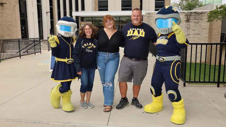 UToledo mascots Rocksy and Rocky pose for a photo with Kim Crawford, a freshman pharmacy major, and her parents, Beth and Larry Crawford during move-in day at UToledo.