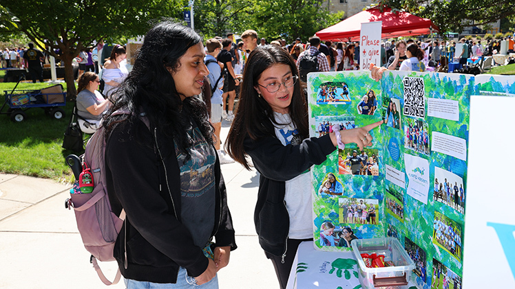 Christina Vargas, left, talks with Anagaa Nathan — both seniors in neuroscience — about Camp Kesem, a national non-profit organization that helps support children with cancer, during Wednesday’s Campus Involvement Fair at Centennial Mall. The annual event spotlights student organizations, University services and upcoming programs and draws hundreds of students and campus partners.