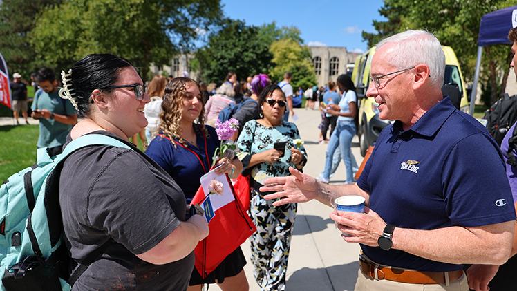 From left, Lydia Holland, a first-year graduate student in social work) and Madison Burkhart, a junior studying recreational therapy, talk with President James Holloway at the Campus Involvement Fair.