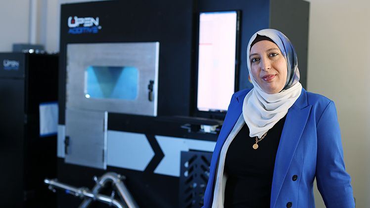 Dr. Ala Qattawi, an associate professor in the Department of Mechanical, Industrial and Manufacturing Engineering, stands in her lab.