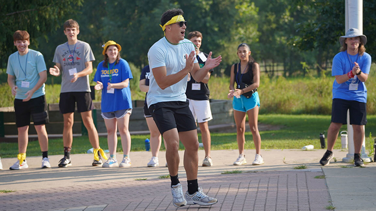 Camp counselor Cardi Wooward, a junior studying electrical engineering, gets one of the groups pumped up for an activity.