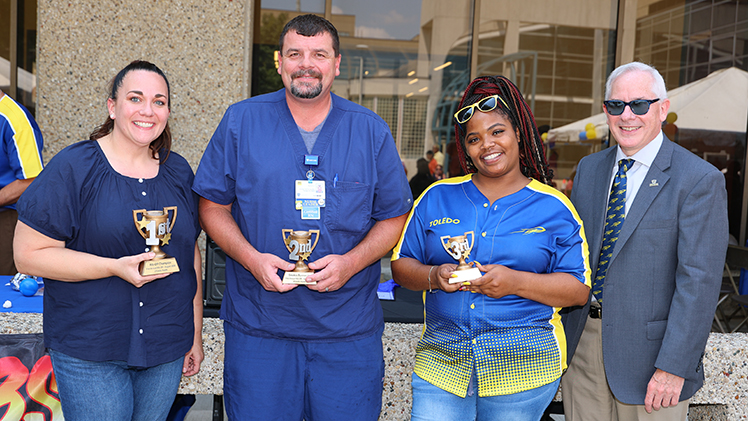 UToledo President James Holloway poses with winners of the event’s first rib-off, from left, Bryna Benninghoff, first place; Ken Fry, second place; and Jamie Easter, third place.