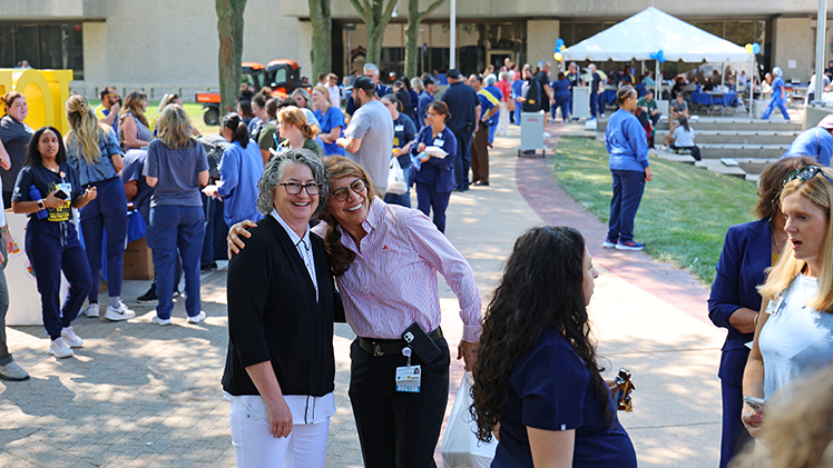 Kim Koesters, director of administrative operations in the College of Medicine and Life Sciences, shares a hug with Dr. Carolina Wishner, an associate professor and director of didactic education in the Physician Assistant Studies Program in the College of Medicine and Life Sciences.