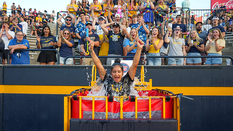 Photo of a UToledo student emerging for The Touchdown Tank after being dunked following a Rocket touchdown.