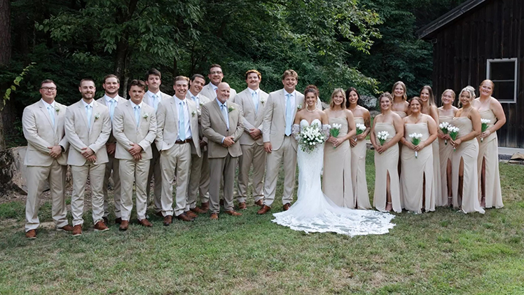 Photo of Tucker Gleason and his wife Emma and their groomsmen and bridesmaids along with Toledo's Offensive Coordinator/Quarterbacks Coach Rob Weiner, who served as the officiant.
