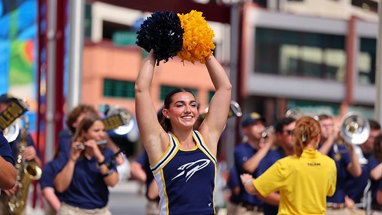 The Toledo cheerleading team and Rocket Marchign Band perform at a downtown pep rally.