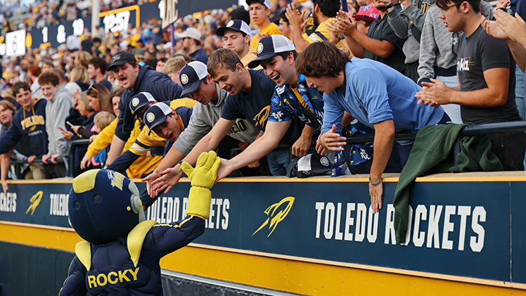 Rocky greets students in the student section of Glass Bowl stadium during a game.