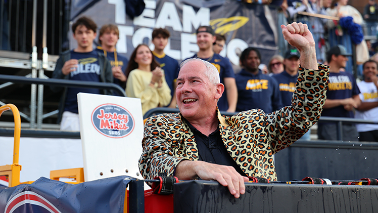 UToledo President James Holloway celebrates as he became the first fan to be dunked in the 2025-26 football season in the "Touchdown Tank."