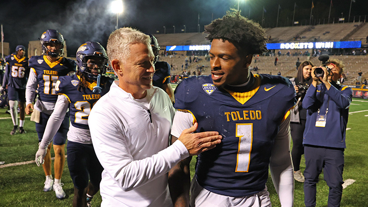 UT Football Head Coach Jason Candle and senior running back Chip Trayanum walk off the field after Toledo dominated Western Kentucky University from start to finish in a 45-21 victory at the Glass Bowl on Saturday night.