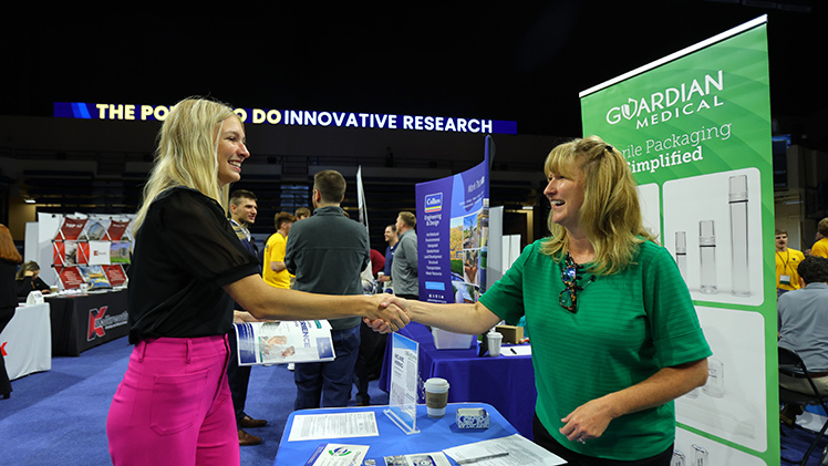 Rebekah Zadrazil, a sophomore in bioengineering, speaks with Susan Witt, a representative with Guardian Medical USA, during the Engineering Career Expo.