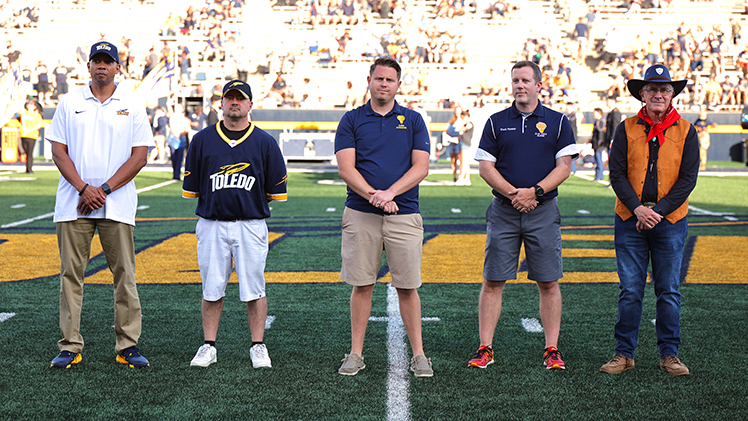 The Alumni Association also recognized some of its Homecoming Gala award winners. From left, William Pierce, associate vice president of alumni engagement; Jason Graven, the Gold T award recipient; Robert “Reggie” Bradley, Jr., the Daniel J. Saevig Blue T award recipient; Matt McClure, president of the Alumni Association Board; and UToledo President James Holloway.