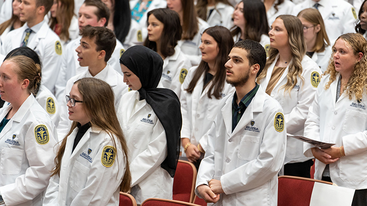 Students in the Doctor of Pharmacy Program, Master of Science in Pharmaceutical Sciences and Bachelor of Science in Pharmaceutical Sciences programs recite a professionalism pledge after receiving their white coats.