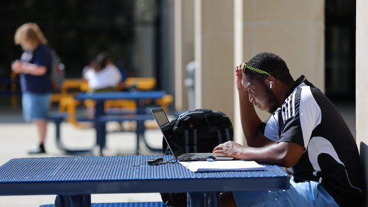 D’Andre Grant, a sophomore in Computer Science and Engineering, takes a break Wednesday afternoon to study at a table outside of Thompson Student Union.