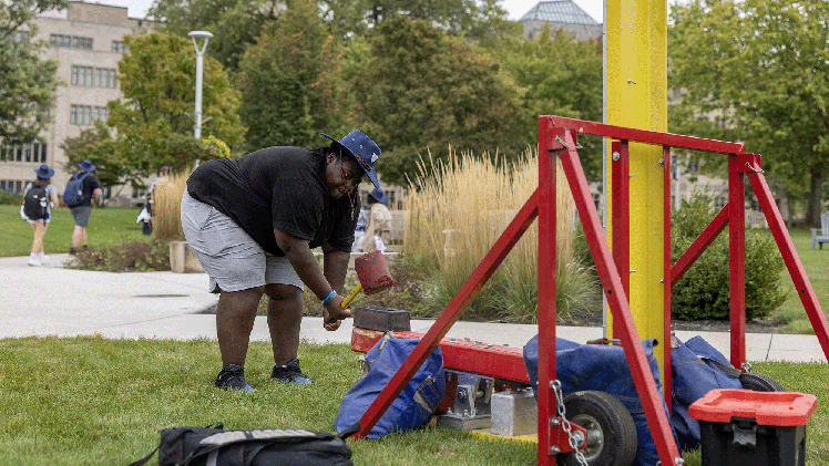 DeJay Mcnear, a communication freshman, plays the high striker game at Eat The Streets in Centennial Mall.